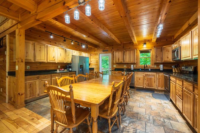 Great room with a stone wood-burning fireplace and smart TV