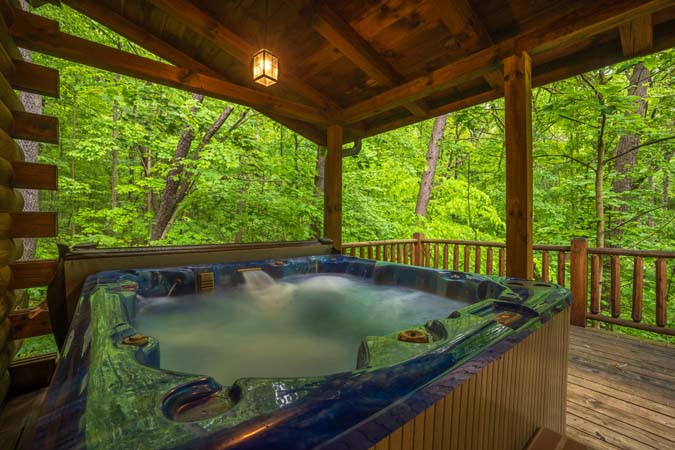 Private hot tub on a covered deck in the woods