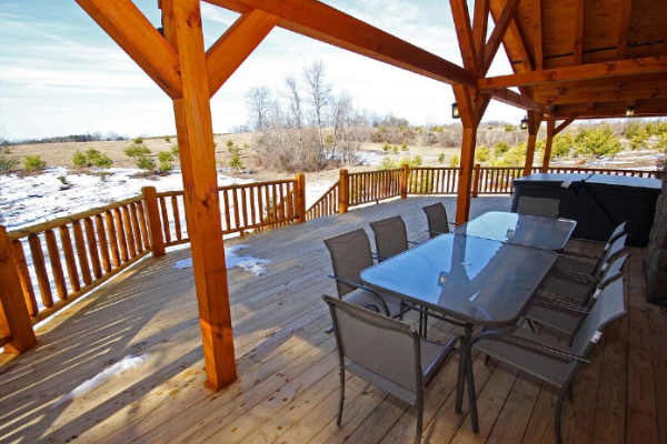 Wooden cabin deck with a dining table