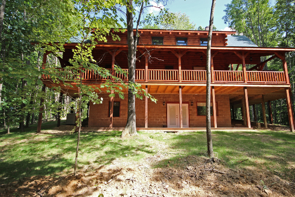 Rear of Lodge, showing Walkout Exit and porch on ground level, Back of Wrap-Around Main-Level Porch  and Gable with windows.