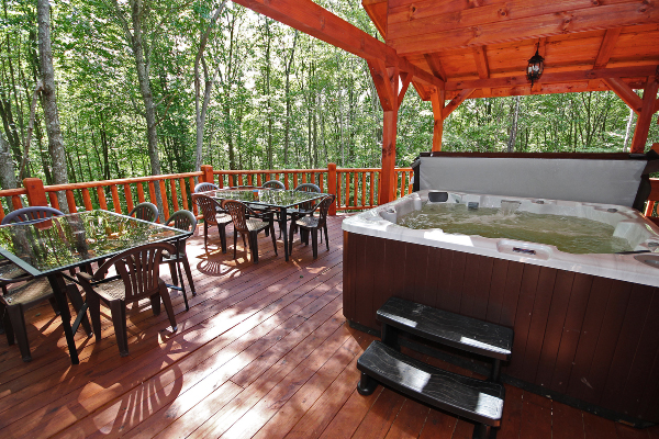 Closer View of Hot Tub 1, with steps leading into hot Tub, with some of the tables and chairs on left.
