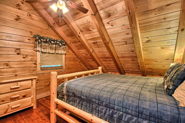 Private Bedroom 5, in loft level, with Queen Log Bed and Dresser, window and Ceiling Fan