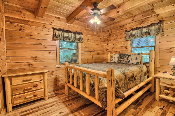 Private Bedroom 1, on main level, with Queen Bed, Dresser and Night Stand, two windows, Ceiling Fan, Hardwood Floor