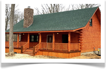 cabin in wooded area with fall leaves on ground